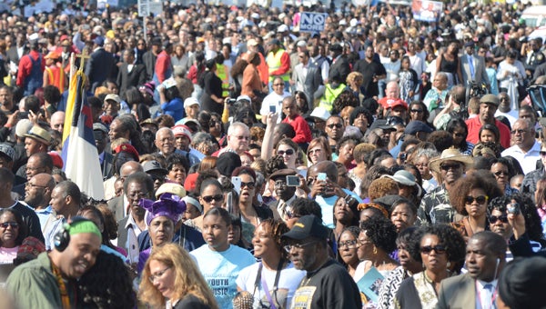Thousands of people march down Broad Street toward the Edmund Pettus Bridge on Sunday during the annual Bridge Crossing Jubilee. (Jay Sowers | Times-Journal)