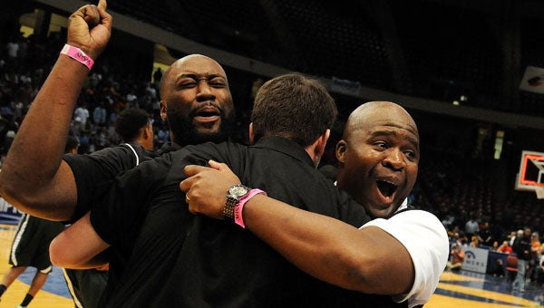 Dallas County head coach Willie Moore, center, is swarmed by assistants after the Hornets won the 4A State Championship over J.O. Johnson. (Jay Sowers | Times-Journal)
