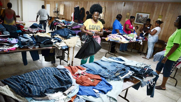Community members look over items during a giveaway Saturday at First Baptist Church in Orrville. (Jay Sowers | Times-Journal)