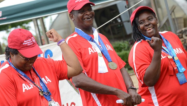 Special Olympians Tonya Pitts, John Shephard and Shariline Norfleet, left to right, share a laugh during an awards ceremony Saturday morning at the Cahaba Center in Selma. (Jay Sowers | Times-Journal)