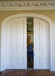 Mandy Henry stands inbetween pocket doors in one of the apartments at the Compton-Fowler house.