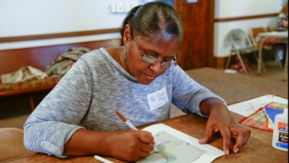 Joyce Flagg works on her quilt square Saturday at St. Paul’s Episcopal Church for the unity quilt being put together by different members of the community.