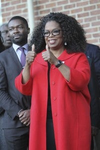 Oprah Winfrey, alongside David Oyelowo, wave to the crowds Sunday at Selma City Hall. 