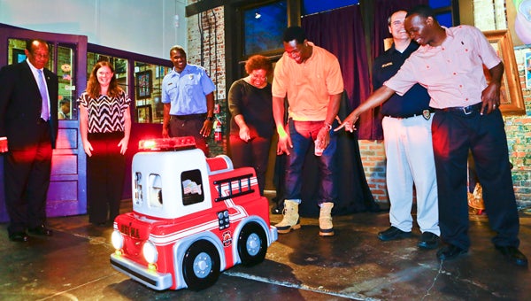Selma Mayor George Evans, Candice Irwin, Daron Waters, Thomasene Johnson, Michael Johnson, Chris Graham and Terrence Venter react to the Selma Fire Department’s newest addition, Engine 3.5. 