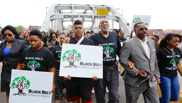 Bill Cosby led a group of marchers over the Edmund Pettus Bridge Friday. --Daniel Evans