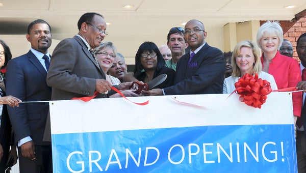 Pastor John Grayson and Mayor George Evans cut the ribbon for the Walton Theater’s grand opening ceremony Friday.