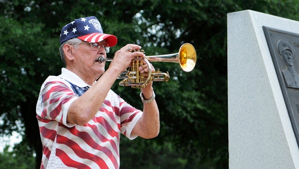Army veteran Jesse Sanchez plays “Taps” on his trumpet at the Memorial Day ceremony Monday at Bloch Park.