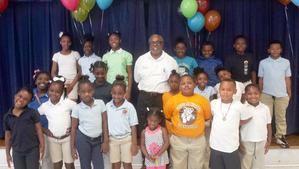 Sophia P. Kingston Elementary School Principal Robert Carter poses with some of his students at a party the school threw for him Thursday. 