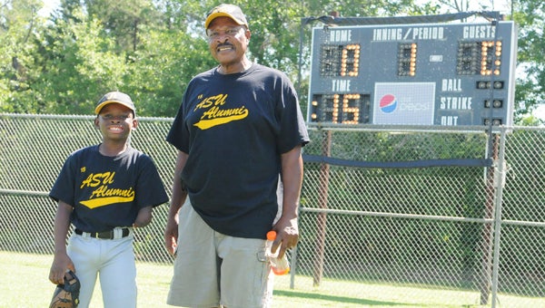 Sherman Norfleet Jr., left, stands with his dad Sherman Norfleet at the Dallas County Sportsplex Saturday.  Norfleet Jr., born with only one hand, plays baseball, football, basketball and occasionally golf.--Daniel Evans