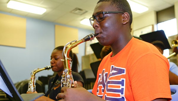 Zarria Howard and Artavious Rhodes play their alto saxophones during Selma High School’s Jazz Band practice Wednesday.