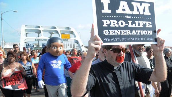 Protesters from all around the United States were in Selma Saturday to march over the Edmund Pettus Bridge and speak out against a Selma women’s clinic they say is performing unlawful abortions.--Daniel Evans