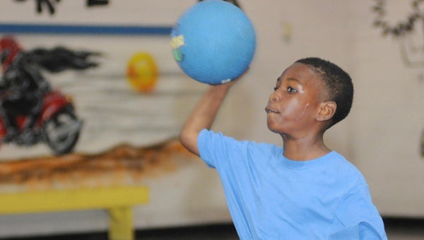 Kendarious Acoff fires a ball during a dodgeball contest Monday at the Selma PALcenter. About 50 youth were on hand for the first day of the center’s summer program.--Daniel Evans