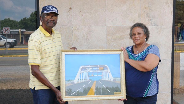 Vernon Spicer and Pearlie Walker pose for a photo outside the National Voting Rights Museum. Spicer donated a spaghetti portrait of the Edmund Pettus Bridge to the museum. --Tyra Jackson