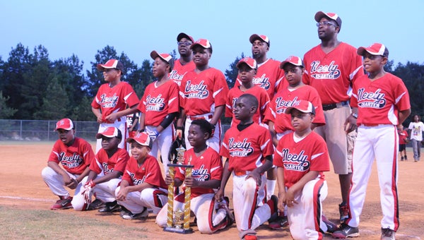  Neely Charter players pose with the 9-and 10-year-old championship trophy Friday night after their 13-2 win over Robinson’s Legal Eagles at the Dallas County Sportsplex. --Derek Thompson