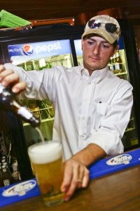 Tally-Ho Restaurant owner Paul Wilkerson pours a beer for a patron Wednesday night. 
