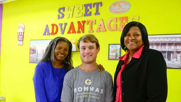Selma City Councilwoman Angela Benjamin, G Mommas Cookies owner Robert Armstrong and Sweet Advantages owner Towanda Friday pose for a picture Monday.  A “cookies and cream” event was meant to celebrate Sweet Advantages grand re-opening and to draw attention to G Mommas’ bid for a free Super Bowl commercial. 