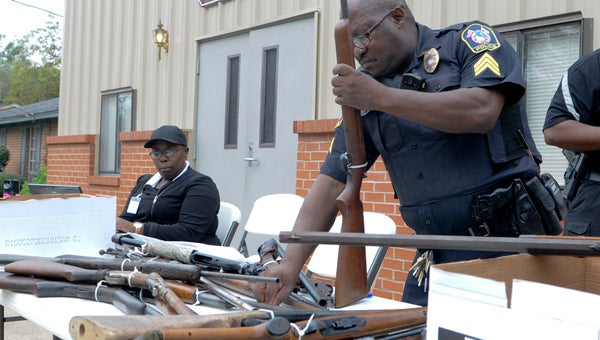 Sgt. Reginald Fitts with the Selma Police Department puts zip ties on one of the 51 guns that were collected in the fourth annual gun buyback program Saturday at Macedonia Apostolic Church.