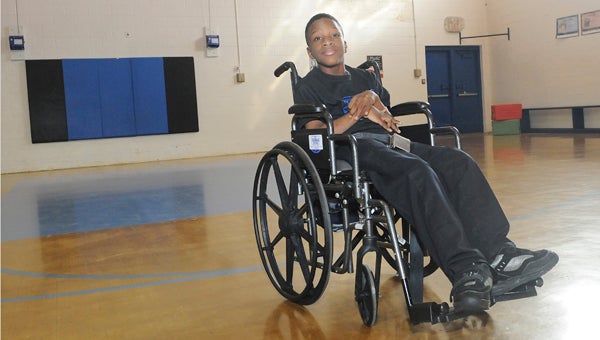 Tipton-Durant Middle Schooler Jyrah Smith poses for a picture Tuesday at the school. Smith, who has cerebral palsy, is an assistant coach for Tipton’s girls’ basketball team. --Daniel Evans