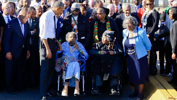 Amelia Boynton Robinson joins President Barack Obama during his walk over the Edmund Pettus Bridge during the 50th anniversary of Bloody Sunday in 2015. -- File Photo