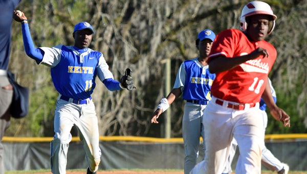 Keith third baseman John Pettway attempts to throw out Southside’s G’Neil Johnson at home plate during Tuesday’s game at Bloch Park.  Before Pettway could finish his throw, the ball was ruled to be in foul territory.  --Daniel Evans