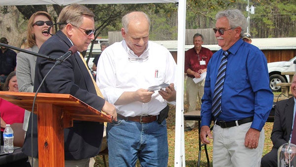 From left, Thomaston Mayor Jeff Laduron presents Dave Market’s Dave Oliver and ADECA State Director Jim Byard with keys to the city. --Robert Blankenship | Demopolis Times