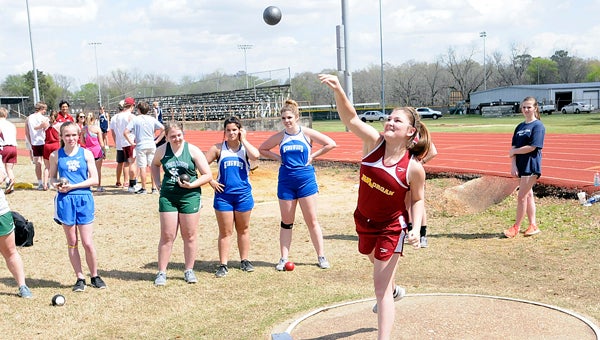 Above, Morgan Academy’s Anna Gayle Hubbard throws the discus during Monday’s track meet at Morgan Academy.  Below, Morgan Academy’s Jaycee Sanders runs during the 3200 meter run.  Sanders won the 3200 meter during Monday’s event. --Daniel Evans