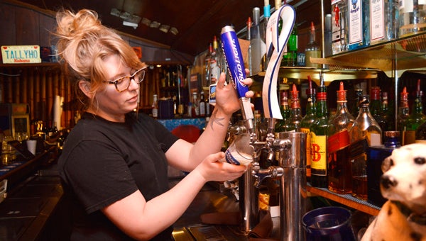 Tally Ho bartender Ashley Strickland pours a draft beer on Monday evening. --Emily Enfinger