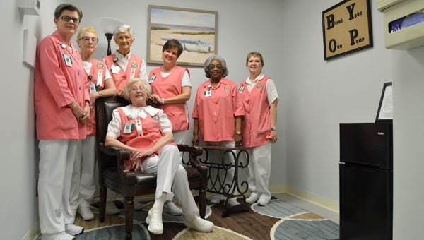 Vaughan Regional Medical Center Auxiliary volunteers pose for a photo in the New Mom’s Lounge on Wednesday.