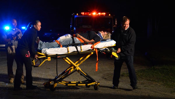 During training Tuesday at the Alabama Police Academy, CARE Ambulance paramedics transport actor Lisa Giles from the scene of a mock accident. 