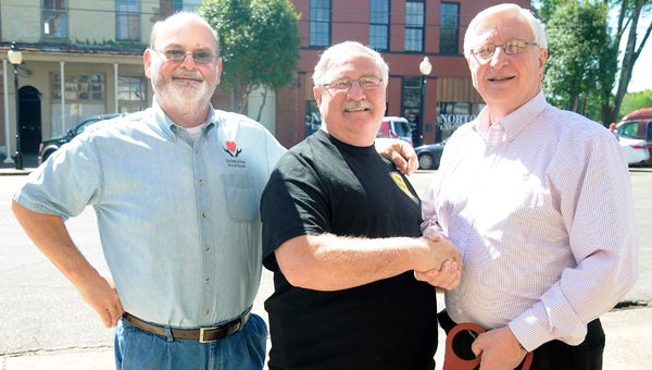 Chamber of Commerce board members Jeff Harrison, left, and Norm Trotter, right, congratulate Charlie Morgan (middle) on the opening of his new restaurant Charlie’s Place.  --Chelsea Vance