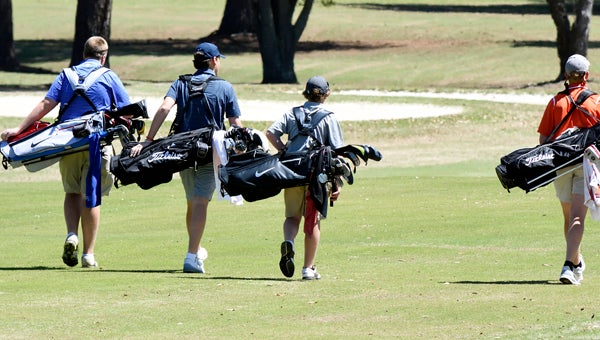  Morgan Academy’s Jones Free walks with playing partners Bryson O’ Malley and Ben Lempicki down the first fairway of Thurdsay’s tournament at the Selma Country Club. — Daniel Evans