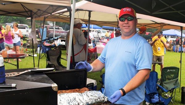  Lee Calame grills ribs for the Trustmark Bank team during this year’s Rock ‘N’ Ribs benefit Saturday at Lions Fair Park. 