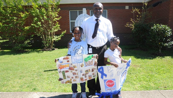 Sophia P. Kingston Principal Major Burrell is shown with students Amiyah Davis and Chasity Green during a diabetes walk at the school Thursday. 