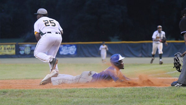 Selma University’s Ricky Butts slides into home plate during the Bulldogs 16-9 victory over Concordia College Alabama Friday night at Bloch Park.  Below, Concordia’s Derrick Johnson throws a pitch during the game.  --Justin Fedich