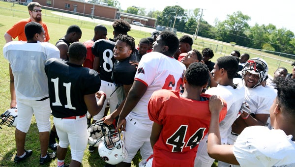 Above, Southside football players huddle during a spring training practice last week. Under a new AHSAA rule change, both sports will have extra time for competition during the summer. --File Photo