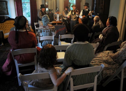 Re-enactors listen to the Un-Reconstructed String Band perform period music in a parlor at Sturdivant Hall Saturday night for the annual Battle of Selma Grand Military Ball. 
