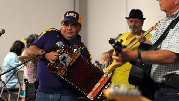 The Back Door Band vocalist and accordionist Glenn Douglas performs during the Low Country Boil.