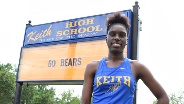  Keith’s Quomila Johnigan poses for a picture in front of the Keith High School sign Thursday afternoon.  --Daniel Evans