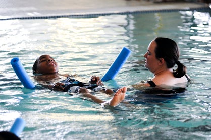 Instructor Skyler Hysler teaches Jaylen Hayes, 11, how to float on his back during the Safety Around the Water class Tuesday. 