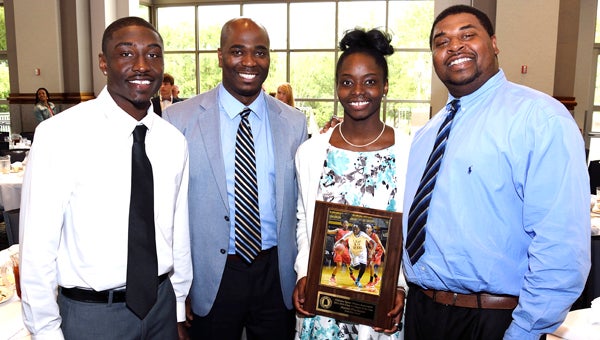 Keith senior John Pettway, Keith athletic director Tommy Tisdale, Keith senior Harriet Winchester and Keith girls basketball coach Cecil Williams pose for a picture at the Alabama Activity Center in Montgomery Wednesday.  Winchester was named 1A Girls Player of the Year.  Pettway was also recognized as a 1A Boys Player of the Year.  --Daniel Evans