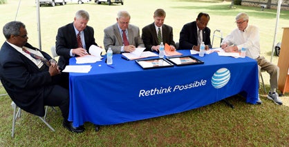 Senator Hank Sanders, AT&T Alabama president Fred McCallum, executive director of the Selma and Dallas County Economic Development Authority Wayne Vardaman, vice president and general manager of Pioneer Electric Terry Moseley, Selma Mayor George Evans and Probate Judge Kim Ballard look over paperwork Monday morning at Pioneer Electric.