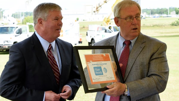 Fred McCallum, president of AT&T Alabama, hands a plaque honoring the South Dallas Industrial Park’s fiber ready distinction to Wayne Vardaman, executive director of the Selma and Dallas County Economic Development Authority.