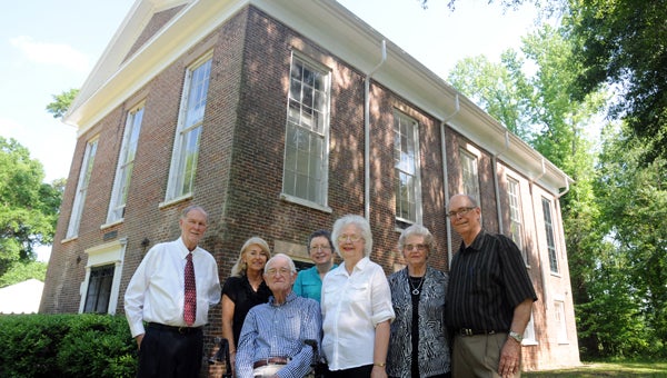 Pastor Dr. Cecil Williamson and church members Christie Cummings, John Russell, Mary Cook, Marjorie Hannah, Lillian Singleton and Carson Llewellyn pose for a photo outside the Valley Creek Presbyterian Church. The church will celebrate its 200th anniversary Sunday. 