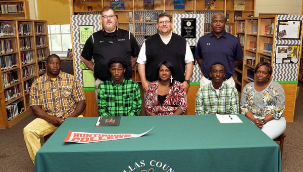 Dallas County High School’s Anthony Oliver and William Lofton signed letters of intent to play college football Tuesday at the school library. Back row: DCHS principal Todd Reece, DCHS football coach Marty Smith, DCHS athletic director Willie Moore; front row:  Anthony Oliver sits with dad Anthony Oliver Sr. and mom Monica Holman; William Lofton and mom Tammy Lofton.  For more photos, see the Times-Journal on Facebook. — Daniel Evans