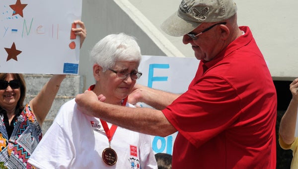  Mary Nell Mayor was awarded a medal by Easter Seals executive director Ronny Johnston on Friday for her many years to the service as an employee, volunteer and fundraiser. 