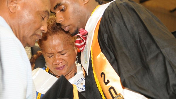 Hattie Pryor, mother of Denetria Pryor, an Ellwood student who passed away April 26, tears up as she accepts a diploma on Denetria’s behalf.