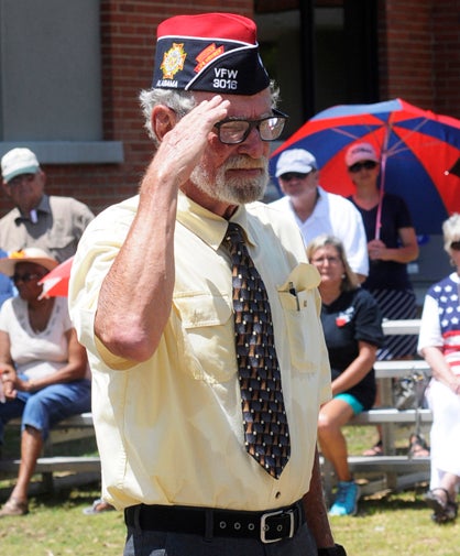 VFW commander Rayburn Hill salutes veterans. 