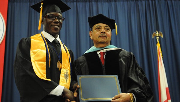 Willie Mason, left, received the James M. Mitchell award Friday from school president James Mitchell at Wallace’s commencement ceremony.