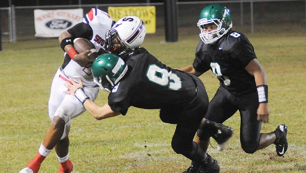 Dallas County’s Patrick Haskell and Delando Atchison tackle Southside’s DeQuan Johnson during a football game last fall.  The teams will play a jamboree this year after playing in the regular season for the last decade. --File Photo