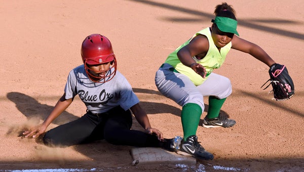 Blue Ox’s Brea Gordon slides into third base safely as TyTianna Johnson tries to tag her out.  --Daniel Evans